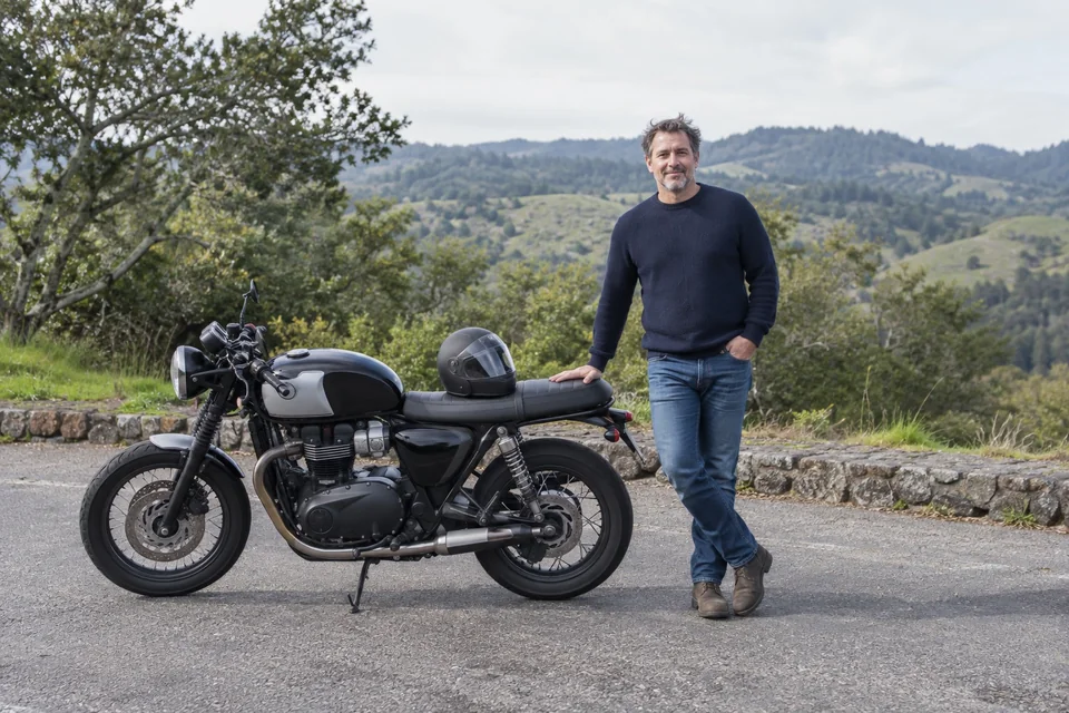 Rider standing beside a bike